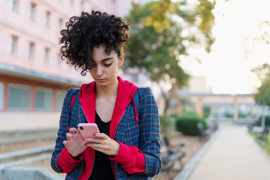 Portrait of young woman using mobile phone outdoors
