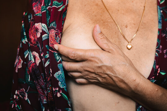 Close-up of a senior woman touching her breast