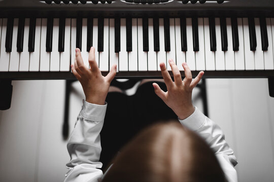 Top view of a girl playing synthesizer