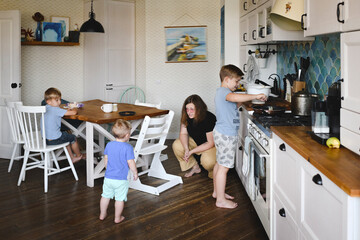 Mother with her three sons in the kitchen