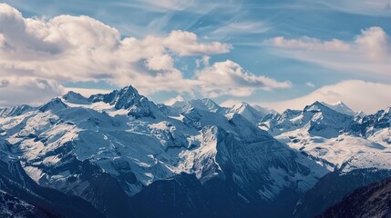 Obraz premium Scenery of the Blue Snow Mountain Range,panoramic view of the Alps—Towering Peaks in Azure Tones, Snow-Capped Summits & Vast Landscapes, Nature’s Breathtaking Alpine Canvas.