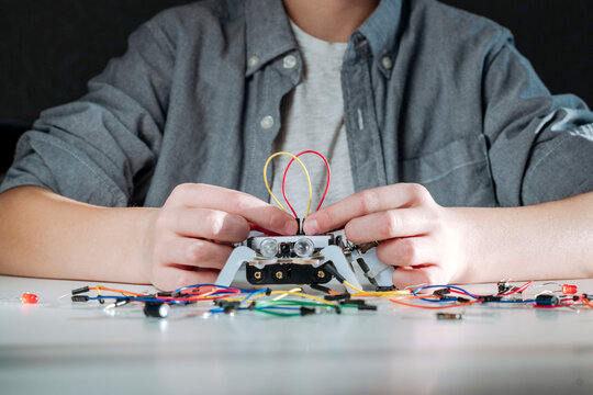 Boy assembling robot at home