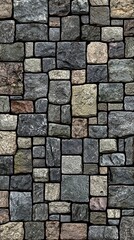 Fototapeta premium Stone wall gray, tan, and brown, irregularly shaped blocks, stacked tightly