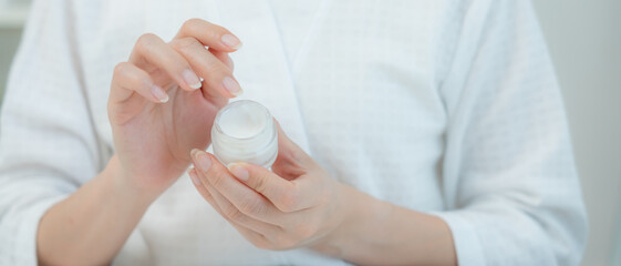 Good skin woman use cream for good skin. face of a healthy woman apply cream and makeup. Advertisement for skin cream, anti-wrinkle, baby face, whitening, moisturizer