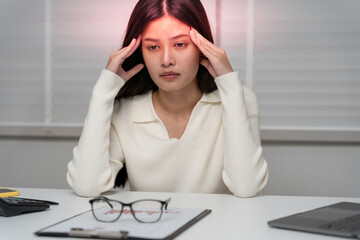Headache, female having migraine pain, bad health, Asian woman feeling stress and headache, Office syndrome, sad tired touching forehead having migraine or depression, irritated girl, sadness grief