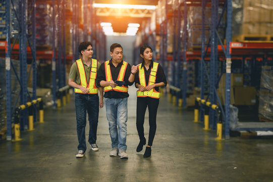 warehouse managers hold clipboard of perform inventory stock goods check list and talking with employees. group of warehouse employees.