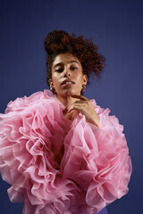 Vertical portrait shot of young adult woman posing confidently in fashion photoshoot, wearing...