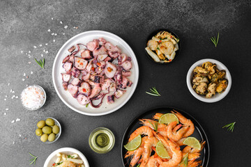 Shrimp, octopus, olives, garlic in bowls for seafood platter or tapas concept