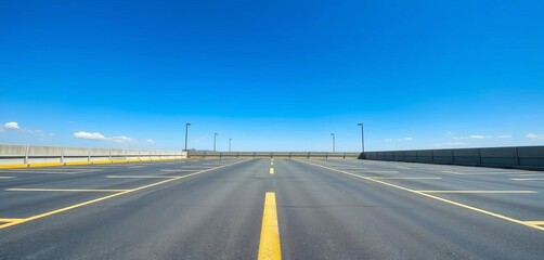 Fototapeta premium Vast, empty asphalt parking lot under a clear sky, pavement, summer