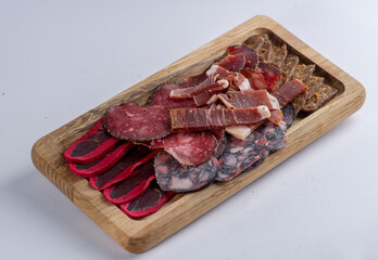 Board with a set of sausages of different varieties for appetizers