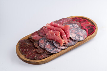 Board with a set of sausages of different varieties for appetizers