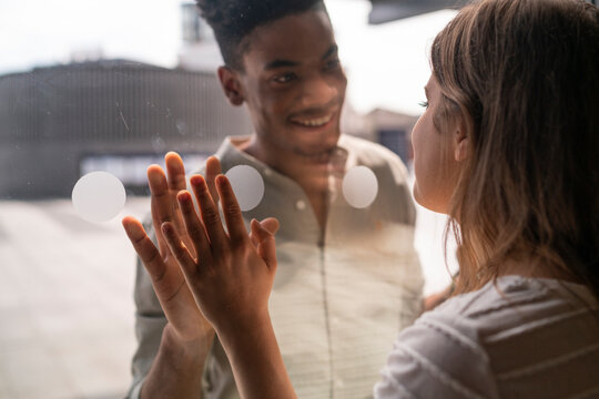 Young woman saying saying goodbye to leaving boyfriend