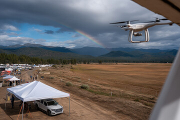 drones assemble above lively festival forming digital canopy that shields attendees from rain