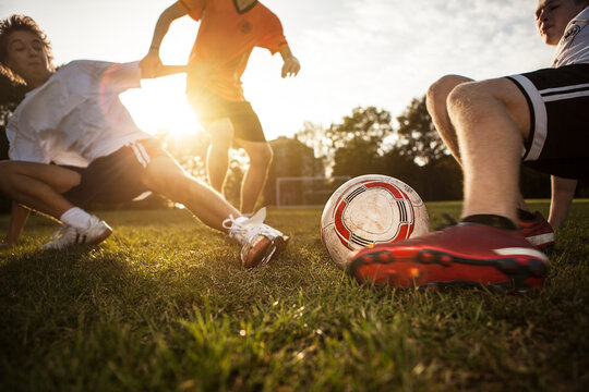 Sliding tackle on soccer pitch