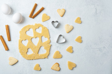 Heart shaped cookies with cinnamon and raw dough for baking or valentines day concept