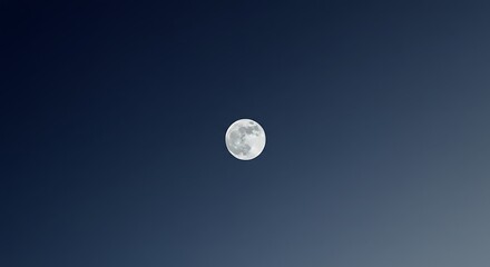 A full moon shines brightly in the dark, clear night sky, its surface detailed with craters and texture against a gradient of deep blue to lighter hues.