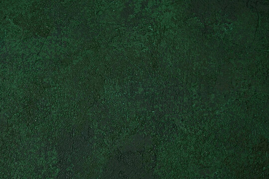 Dark green textured wall with aged rough plaster and grunge pattern