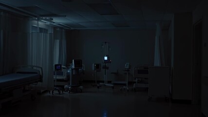 Empty hospital room at night with medical equipment and dim lighting  