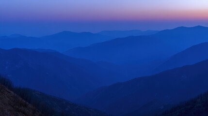 Fototapeta premium Serene Mountain Landscape at Twilight with Deep Blue Hues and Fading Sunset for Natural Backgrounds