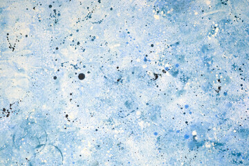 Abstract blue painting with splashes and textures creating depth and movement