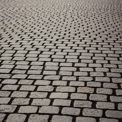 Close-up view of a cobblestone surface, showing texture and pattern.