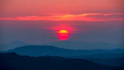 Vibrant Sunset Over Layered Blue Mountains sunrise