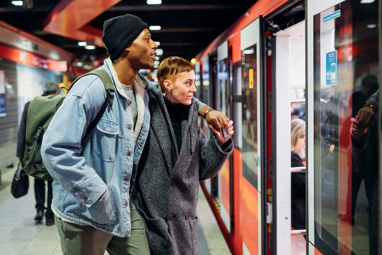 Young couple at the station platform entering subway