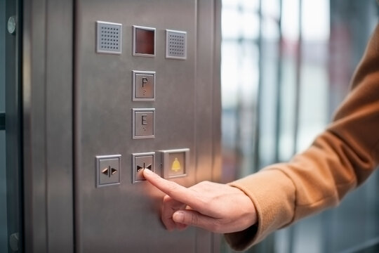 Woman pressing button of a lift