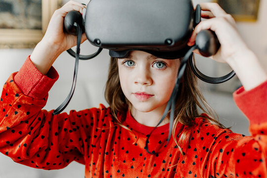 Cute girl wearing virtual reality simulator