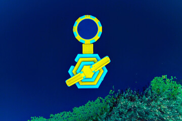 Aerial view of a bright yellow and blue floating structure contrasting against the dark water and green foliage, Kherson, Kherson Oblast, Ukraine.