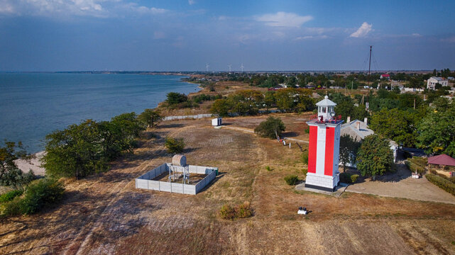 Aerial view of the Luparevskyi Front Lighthouse painted in striking red and white against the backdrop of the sea, Kherson, Kherson Oblast, Ukraine.