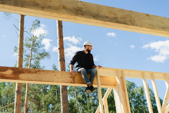 Engineer sitting on wooden frame at construction site