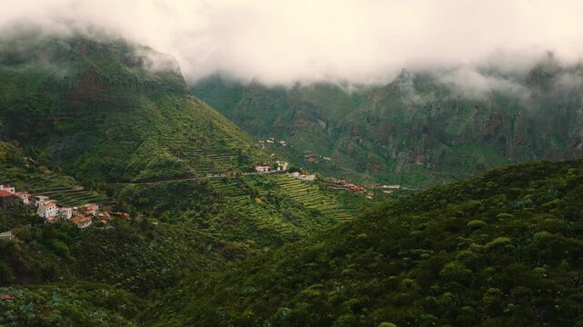 Scenic aerial view of Masca village under clouds with sun rays breaking through, Tenerife, Canary Islands