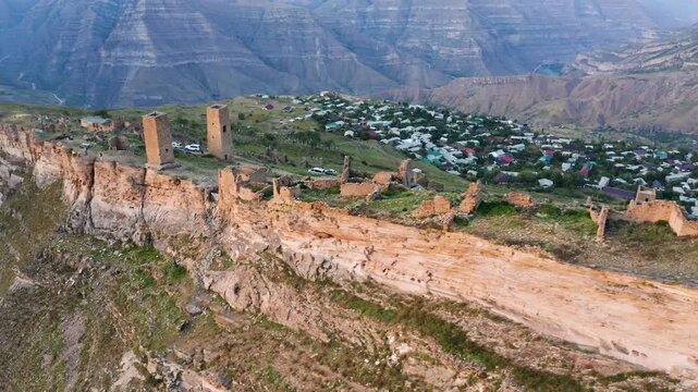 Aerial view of the ancient towers of Goor stand majestically on the cliff edge, showcasing the historic landscape, Goor, Republic of Dagestan, Russia.