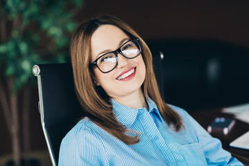 Portrait of a professional businesswoman seated at her desk, exemplifying confidence and positivity...