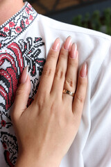 Bride's hand on groom's chest. Marriage.