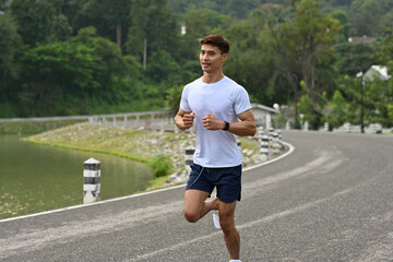 A Runner enjoying a morning jog on a road surrounded by greenery