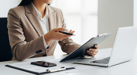 Fototapeta premium Female Professional in a Business Meeting, Working with Laptop and Documents in a Modern Office