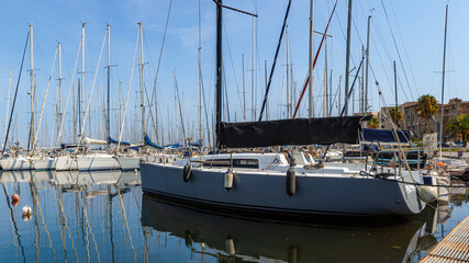 Sailing yachts in the marina of Palermo, Sicily. Yachts on the pier in Italy. Anchorage on the sea. Rigging ropes and cables on the bow of a sailboat