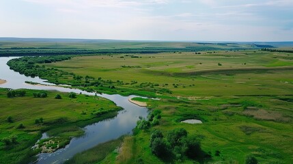 Fototapeta premium Vibrant Grassland River and Green Grassland Backgrounds: Serene Scenes of Meandering Waterways, Lush Green Pastures, Flowing Streams, and Rolling Hills, Perfect for Nature Documentaries, Eco-Tourism
