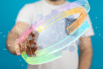 Stock photo of a person interacting with a holographic 3D data visualization interface.