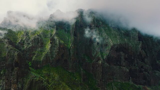 Dramatic vertical cliff near Masca with summit disappearing into clouds, Tenerife, Canary Islands