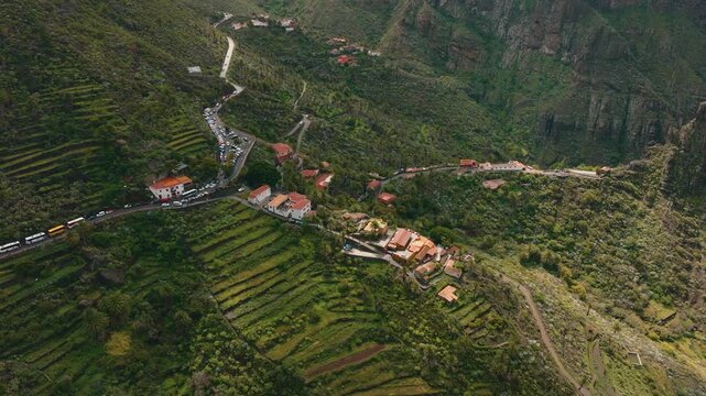 Aerial view of Masca village surrounded by dramatic cliffs and green terraces, Tenerife, Canary Islands