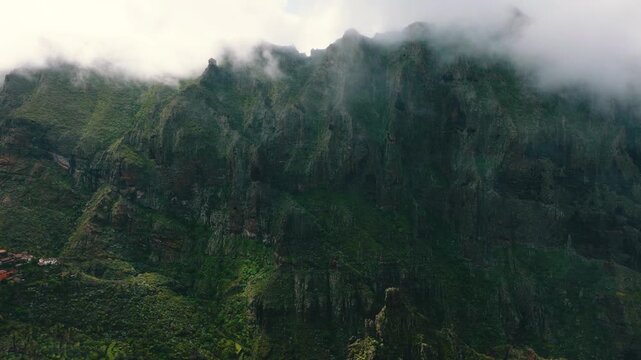 Dramatic vertical cliff near Masca with summit disappearing into clouds, Tenerife, Canary Islands