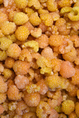 Yellow raspberries in close-up. Juicy sweet yellow berries.
