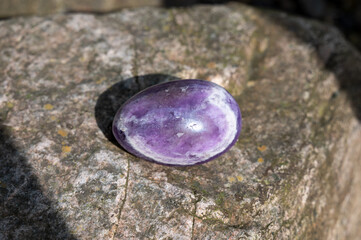 Amethyst egg-shaped on a stone