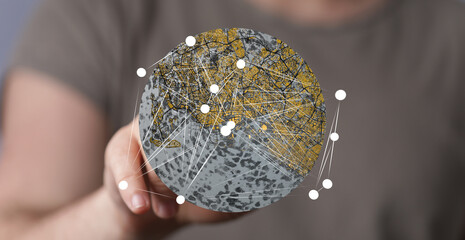 Person holding a digital globe showcasing interconnected nodes.  Represents global network,...