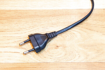 Electrical Plugs on wooden background (selective focus).