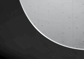 Abstract architectural detail of a curved ceiling, contrasting light gray and dark gray concrete.