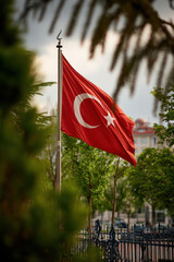 15temmuz for powerful colours signs editable pride vote occasion concept. Turkish flag waving in wind among green trees and iron fence in peaceful outdoor setting